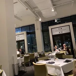 people sitting at tables in a restaurant