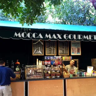 a man standing in front of a coffee shop