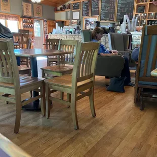 a woman sitting at a table in a restaurant