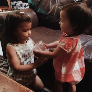 My girls sharing a strawberry smoothie