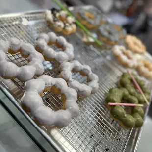 a variety of doughnuts on a cooling rack