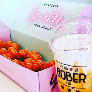 a cup of coffee and a box of donuts