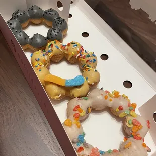Left to right: black sesame, lychee, fruity pebble cereal mochi donut