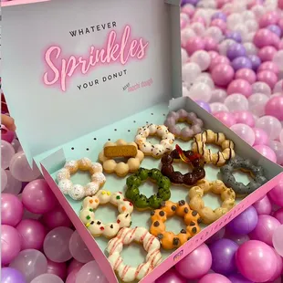 a box of sprinkles and donuts
