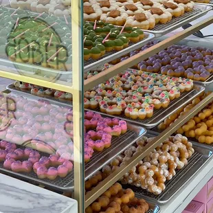a variety of donuts in a display case