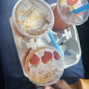 Strawberry tea w passion fruit popping boba, grapefruit tea w mango popping pearls, and a strawberry tea w mango popping boba