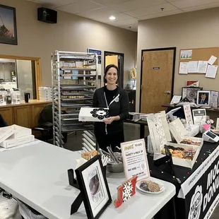 a woman standing in front of a counter