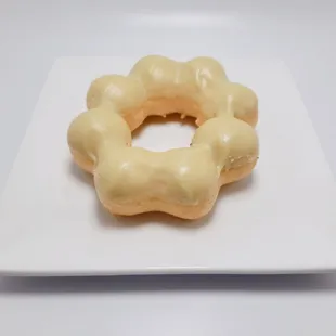 a glazed donut on a square plate