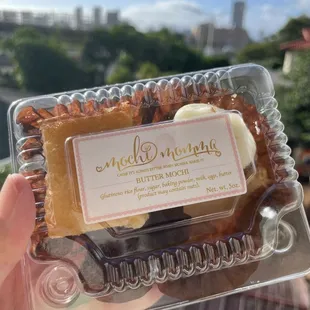 a hand holding a box of cookies