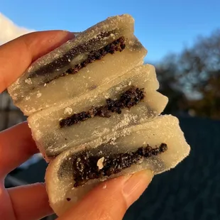 a hand holding a piece of food