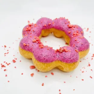 a pink frosted doughnut with sprinkles