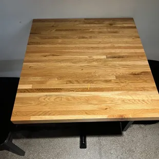 a wooden table with metal legs