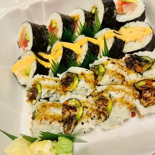 a plate of sushi and vegetables