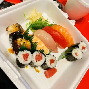 a plate of sushi on a red table