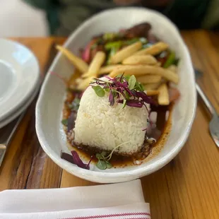 a plate of rice and french fries