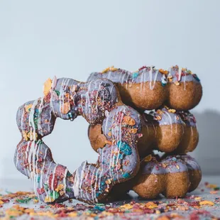 a stack of donuts with sprinkles