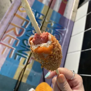 a hand holding a piece of food