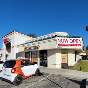  small car parked in front of a restaurant