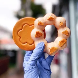 a hand holding a doughnut