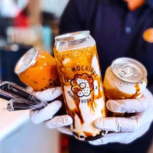 a person holding a can of mocha