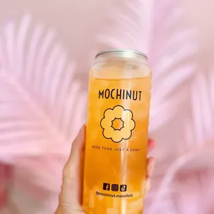 a hand holding a bottle of mochinut