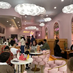 people sitting at tables in a restaurant
