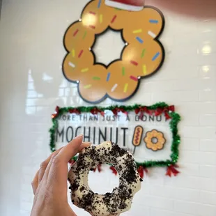 a hand holding a doughnut