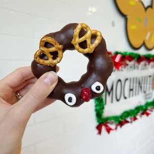 a hand holding a chocolate covered pretzel