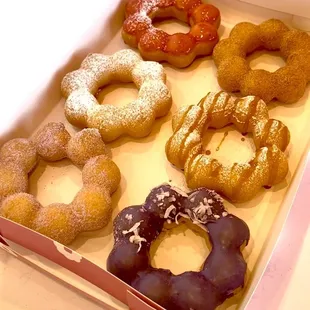 Mochinut Donuts.  Flavors: Strawberry Mango, Churro, Funnel Cake, Caramel Funnel Cake, Ube Sugar and Ube Coconut