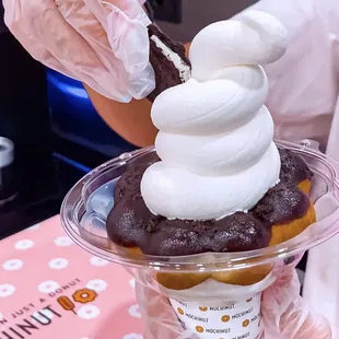 a person holding a cup of ice cream