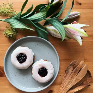 a plate of doughnuts and a wooden spoon