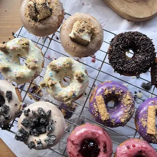 a variety of doughnuts on a cooling rack