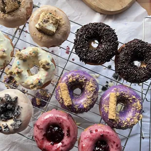 a variety of doughnuts on a cooling rack