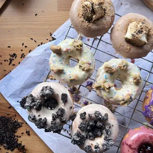 a variety of doughnuts on a cooling rack