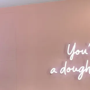 a neon sign that says you&apos;re a doughnut made