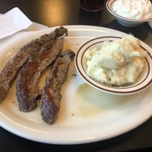 Marinated beef strips and what they consider homemade mashed potatoes.