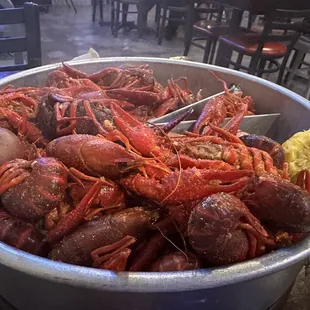 ows a large bowl of crawfish and potatoes