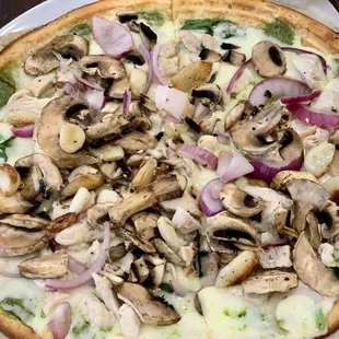 Personalized pizza (cauliflower crust, pesto, white sauce, spinach, mozzarella, garlic, onions, mushrooms, grilled chicken)