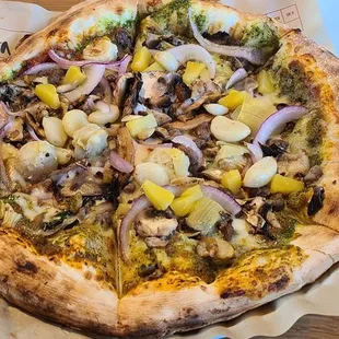 11" mega crust with basil and red sauce, mozerella, red onions, basil, garlic, mushroom, artichokes,  and a dash of pineappl!