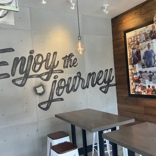 a wall with a sign that says enjoy the journey