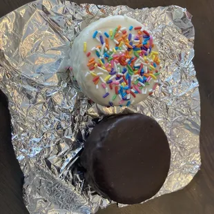 a chocolate covered doughnut and sprinkles
