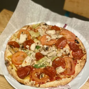 a pizza on a paper plate