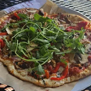 a pizza with vegetables on it