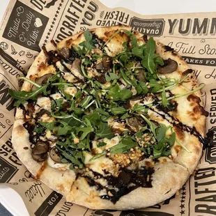 a pizza on a paper plate