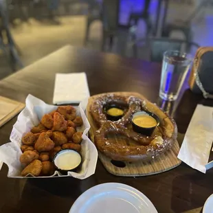 a pretzel and a plate of fried chicken