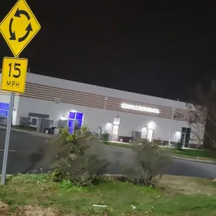 a street sign in front of a gas station