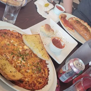 Baked spaghetti pepperoni pizza and pepperoni calzone