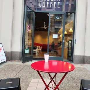 Infront of the coffee shop