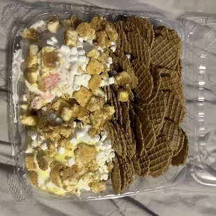 Large nacho with anniversary cake & strawberry cheesecake ice cream. Marshmallow sauce & cheesecake pieces & marshmallow bits