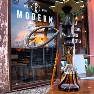 a modern hookah on a wooden table
